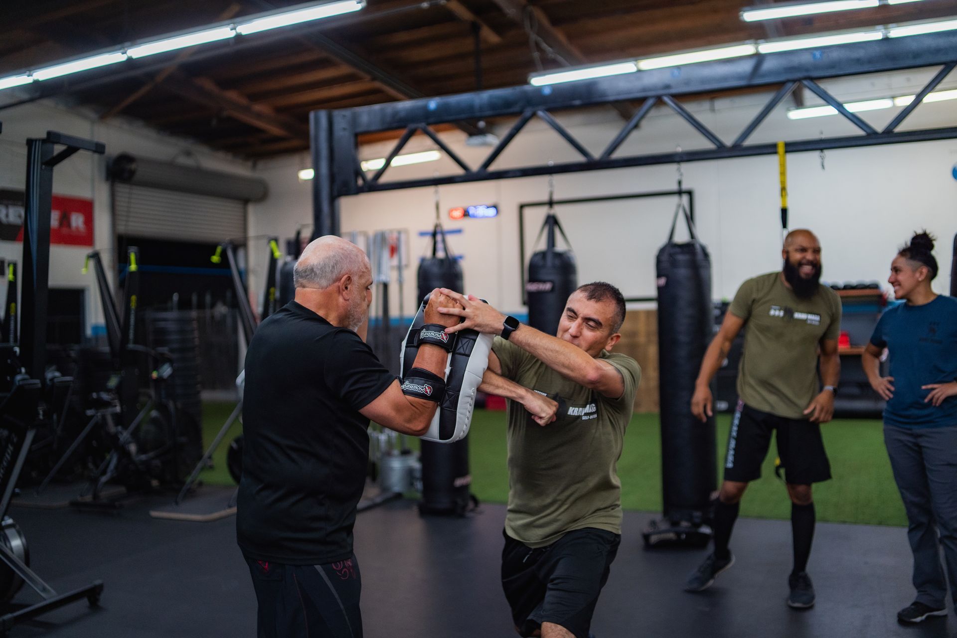 A group of men are practicing martial arts in a gym.