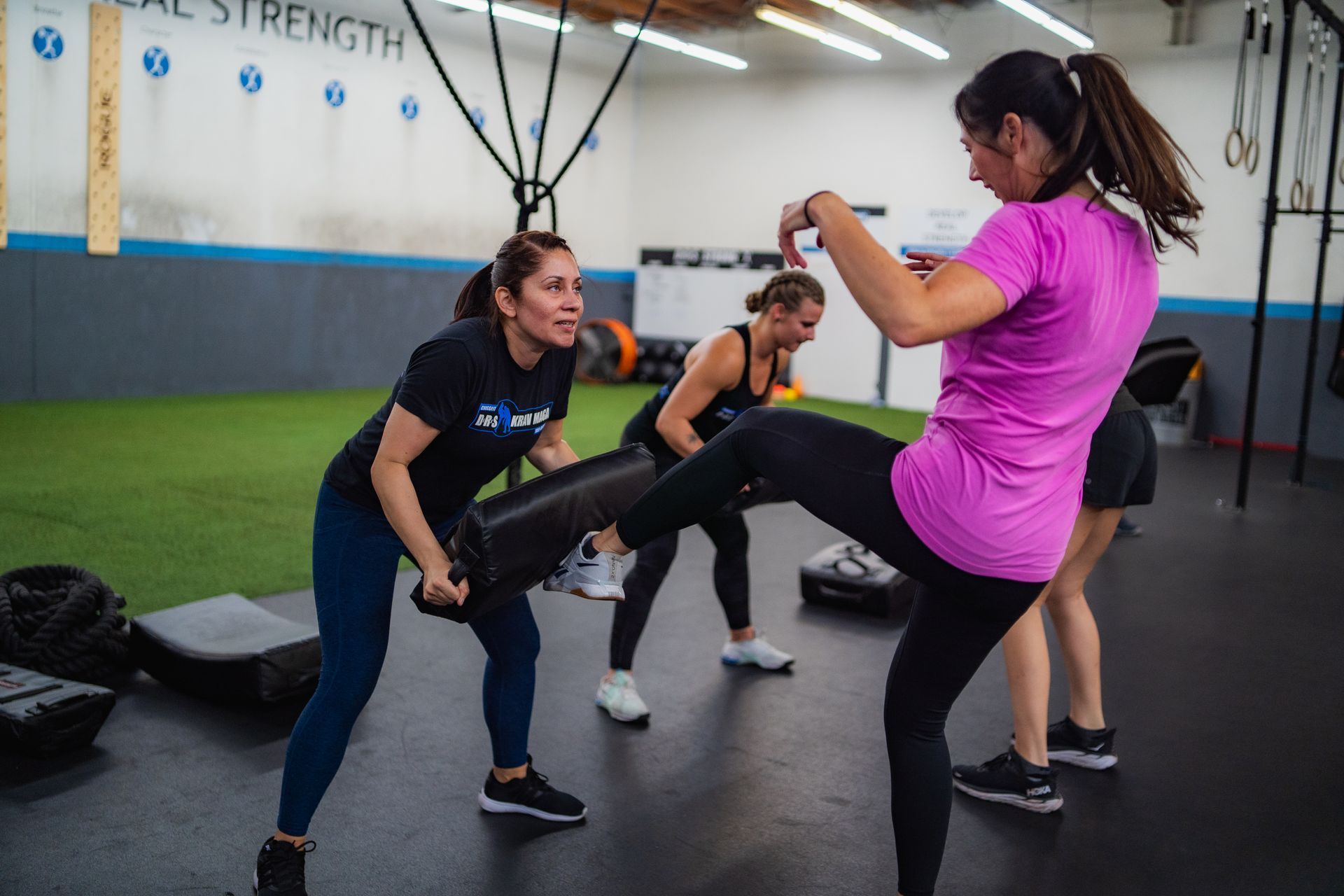 A group of women are doing exercises in a gym.