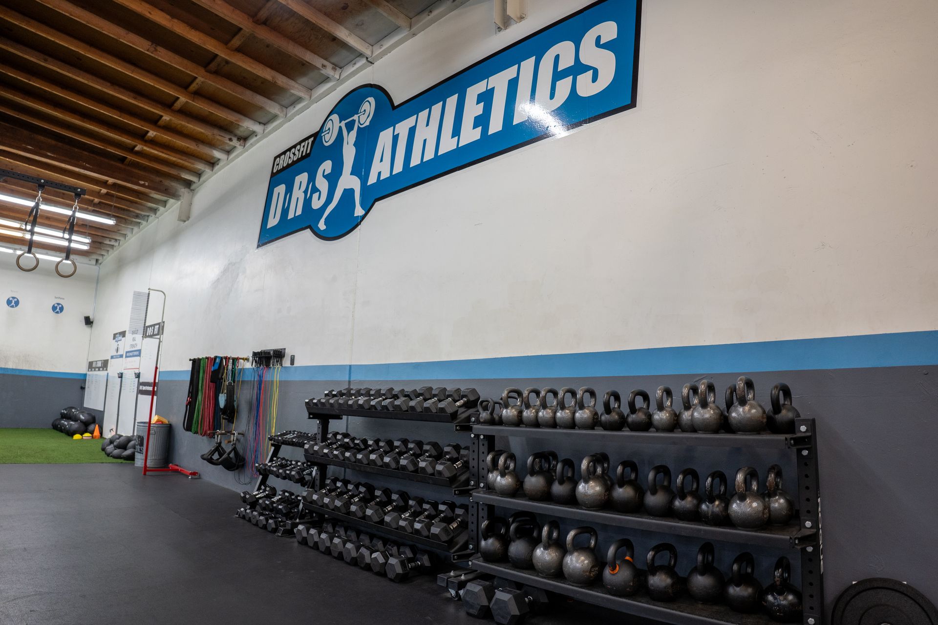 A gym with a sign on the wall that says bbs athletics