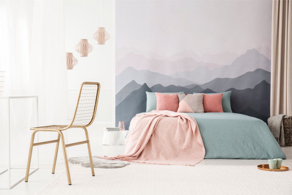 A Bedroom With a Bed, Chair and Mountains Painted on the Wall — The Comfort Zone Darwin In Winnellie, NT