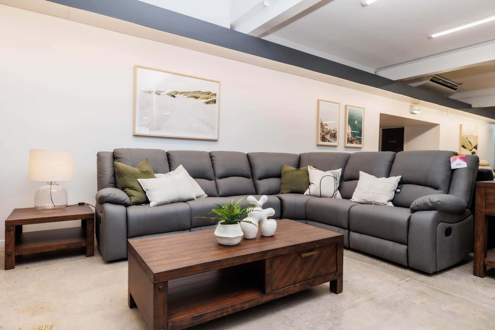 A Grey Couch With Cream and Green Pillows in a Living Room — The Comfort Zone Darwin In Winnellie, NT