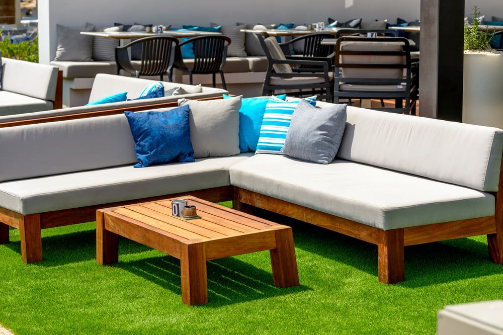 A Patio With a Couch, Table and Chairs on a Lush Green Lawn — The Comfort Zone Darwin In Winnellie, NT