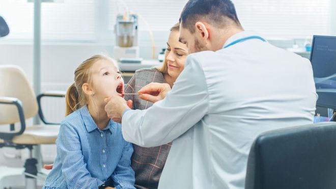 Child having a throat exam done