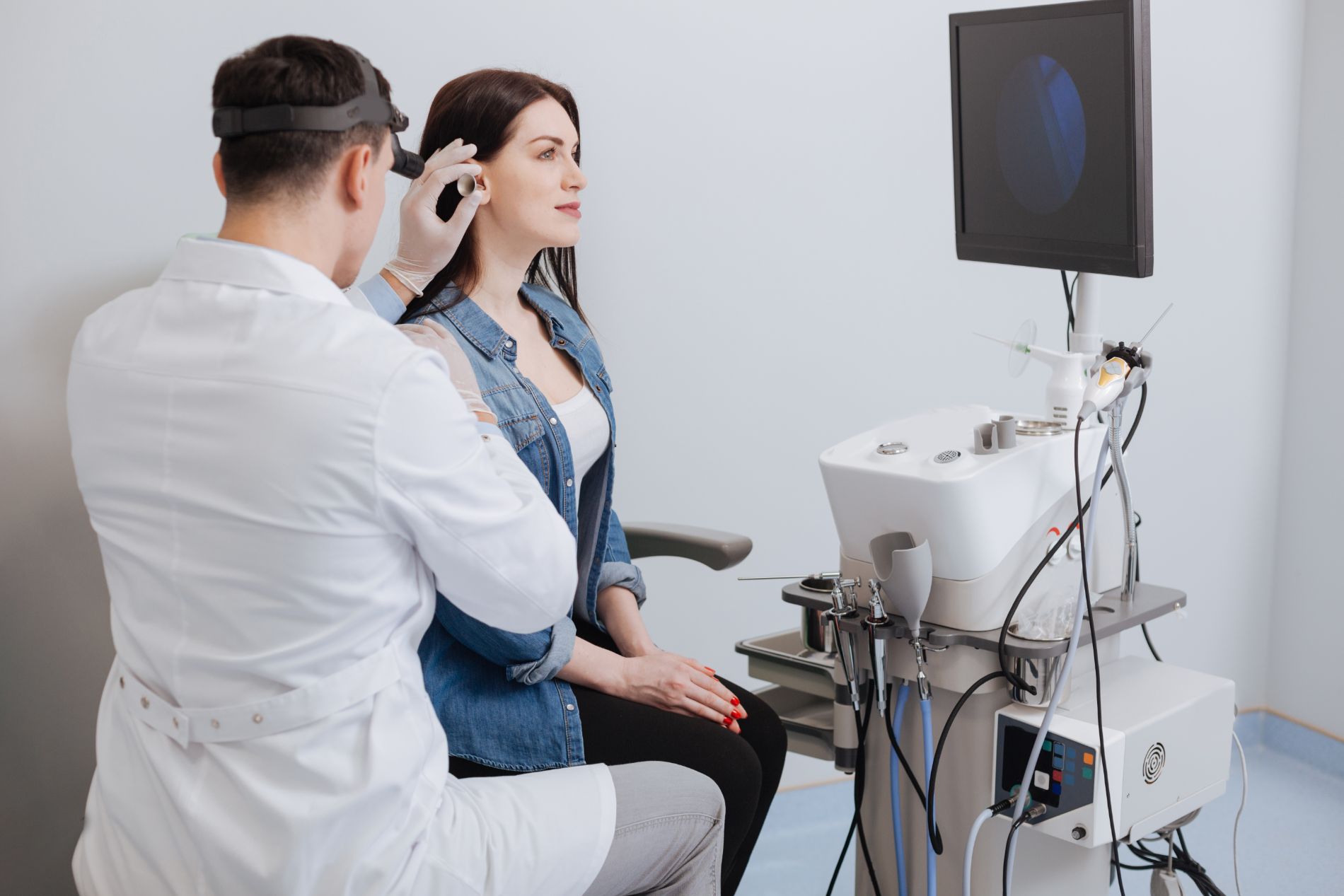 A doctor examining a patient's ear