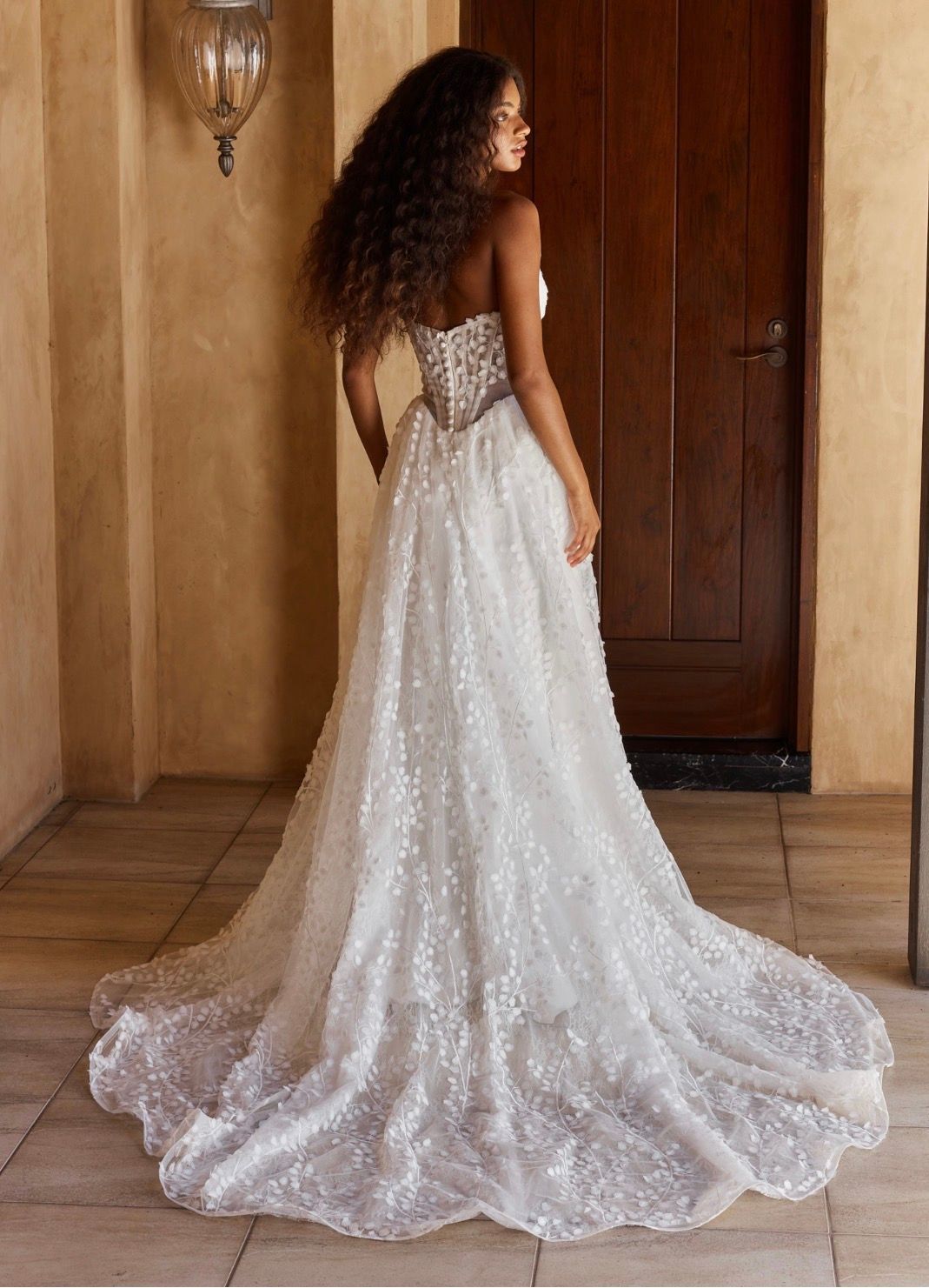 Like a spring meadow, our Oriel wedding dress is a celebration of botanical textures for the romantic modern bride. Designed as a fresh take on our bride favourite Jordan wedding dress, with the same vine-like lace pattern on clean velvet satin. Hidden beneath the layers is pretty Chantilly underlace which creates further dimension.