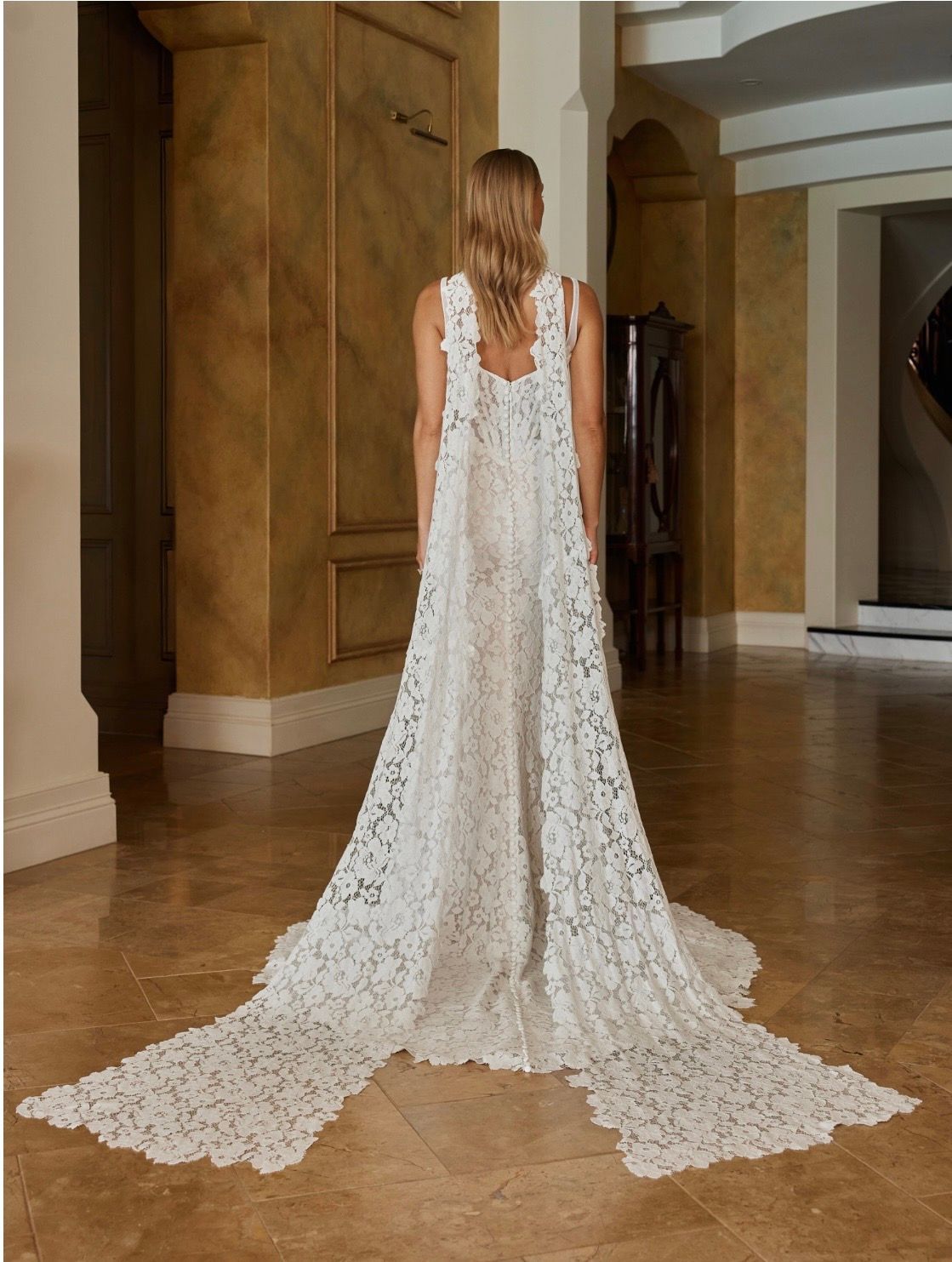Sexy and feminine is our Ora wedding dress with striking vintage-inspired lace and a unique modern elevated design. For our modern Madi brides who want a statement style that feels and looks chic and youthful. Made even more dramatic with a long length matching full lace scarf.
Hitting all the fashion trends, her modern square neckline with tapered illusion shoulder straps frames the illusion tulle bodice. Layered with corded floral lace across the bust and down the centre-front. Using negative space to create sexy curved illusion side corset panels that snatch the figure for the ultimate feminine waistline.