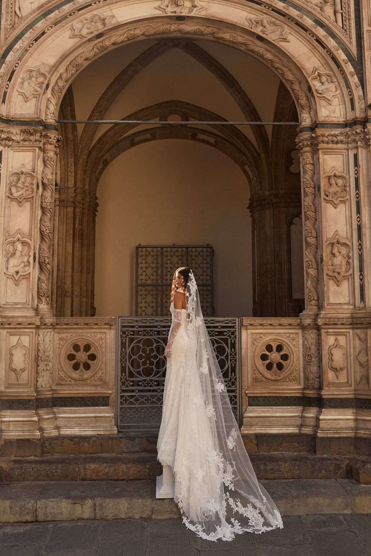 Chantilly lace mermaid gown with delicate spaghetti straps and a fitted silhouette. Featuring soft cups and sculpting panel details that contour the body for an elongated look.
Complement the look with detachable Botticella train, Priss cover dress, Virelda veil, Odyssia gloves, and Ossyn choker for a perfectly completed layered ensemble.