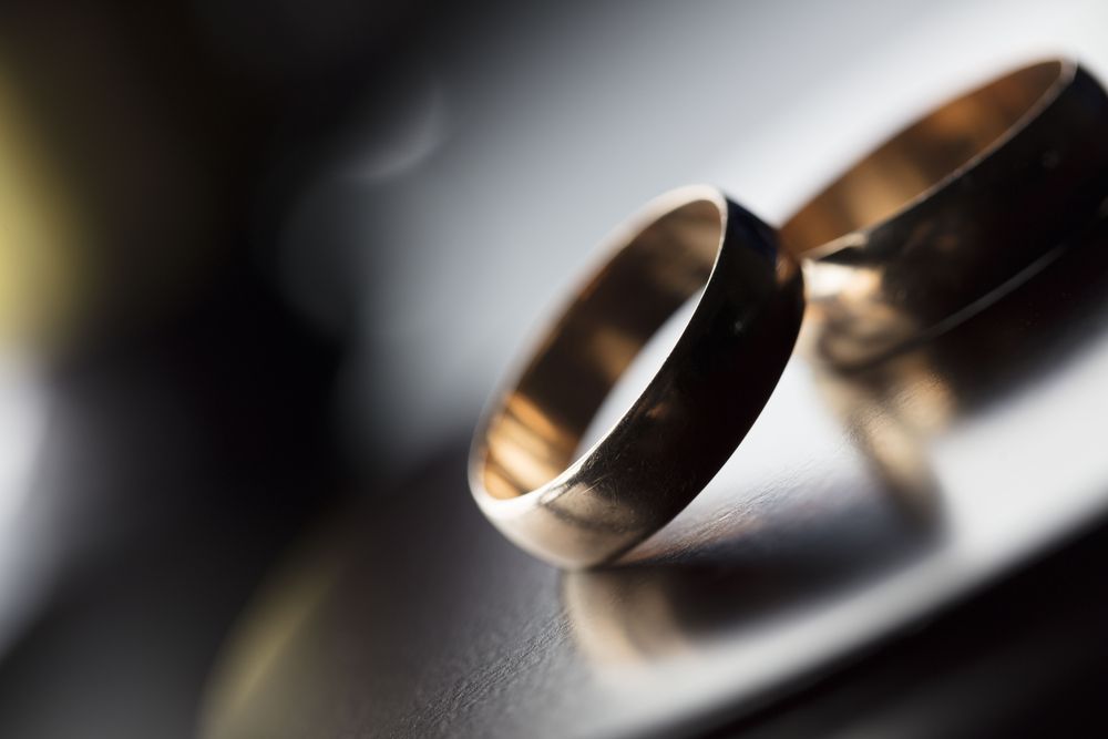 a close up of two wedding rings on a table