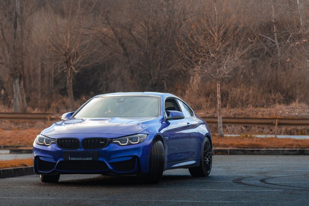 Blue BMW M4 Coupe Parked on Asphalt — Supalook Smash Repairs In Port Macquarie, NSW