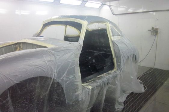 Classic Car in a Paint Booth, Taped and Covered in Plastic, Ready for Paint — Supalook Smash Repairs In Port Macquarie, NSW