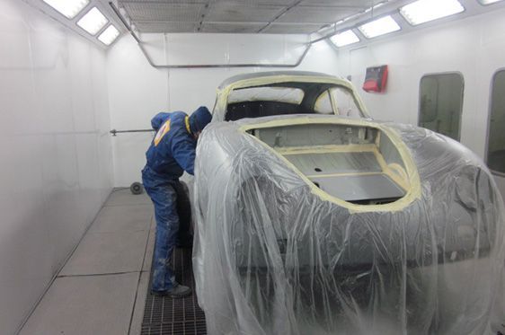 A Person Masks a Classic Car in a Spray Booth, Preparing It for Painting — Supalook Smash Repairs In Port Macquarie, NSW