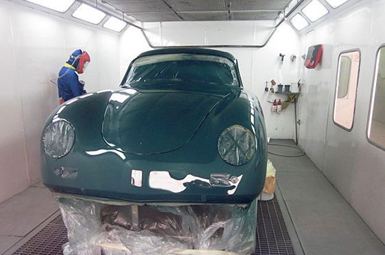 A Classic Green Porsche Being Painted in a Body Shop Spray Booth — Supalook Smash Repairs In Port Macquarie, NSW