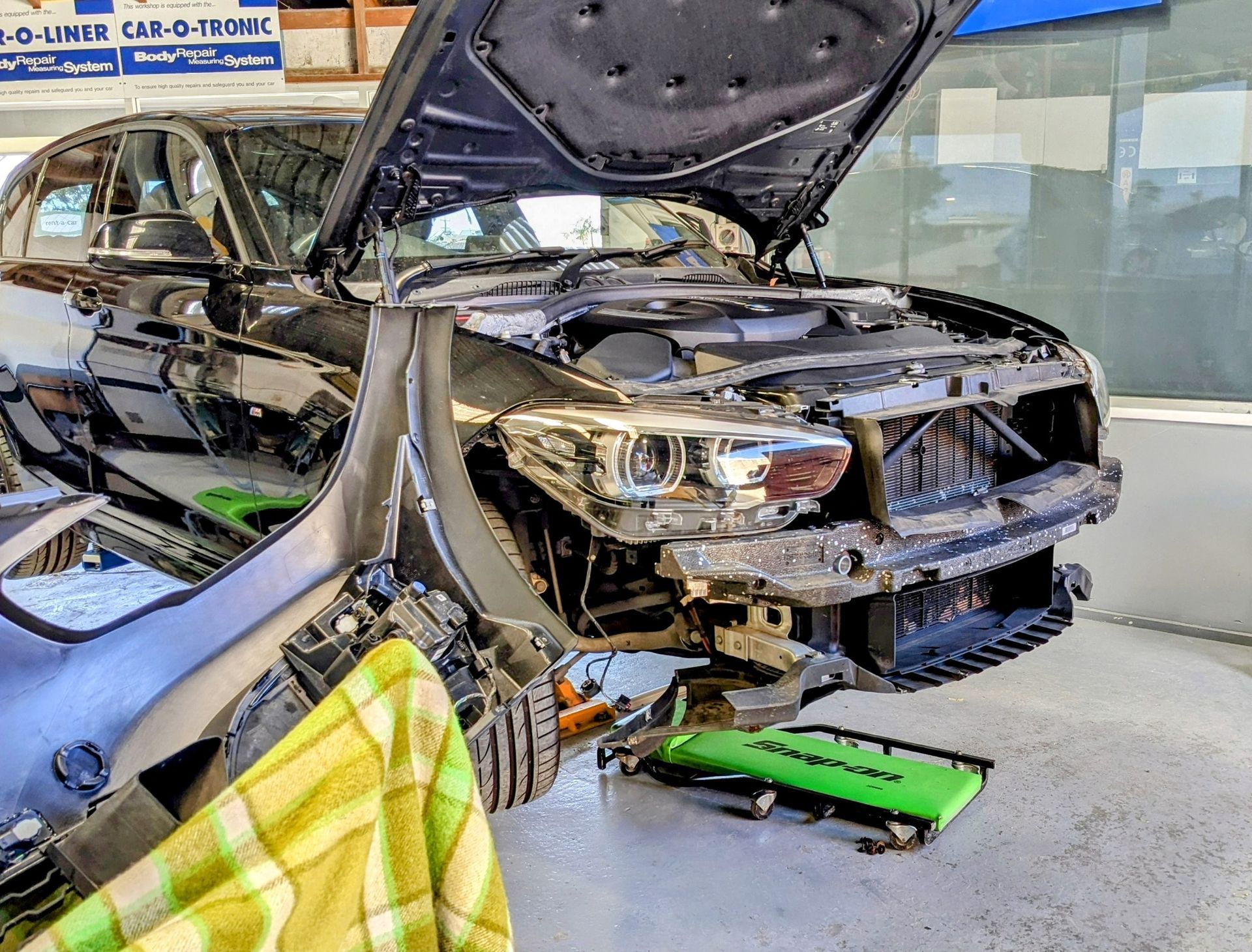 Car With Front End Disassembled in a Repair Shop — Supalook Smash Repairs In Port Macquarie, NSW