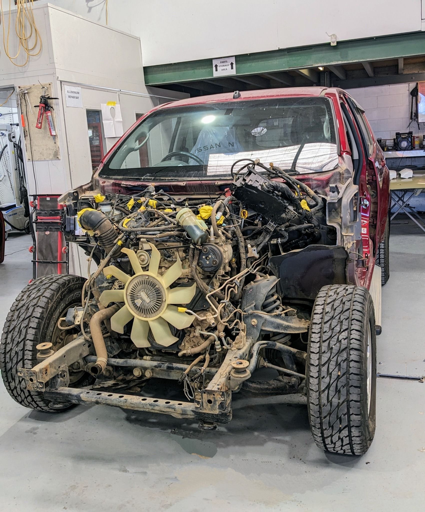 Partially Disassembled Red Pickup Truck in a Repair Shop — Supalook Smash Repairs In Port Macquarie, NSW