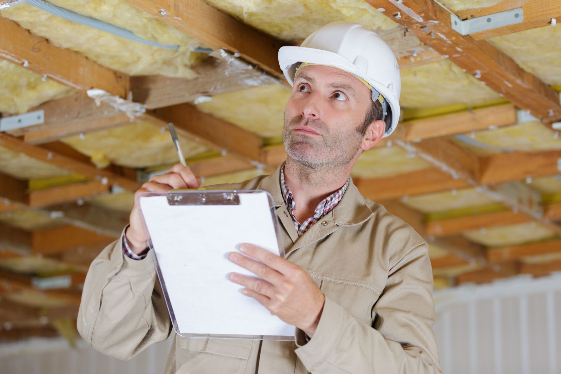 man in a hard hat with a clipboard