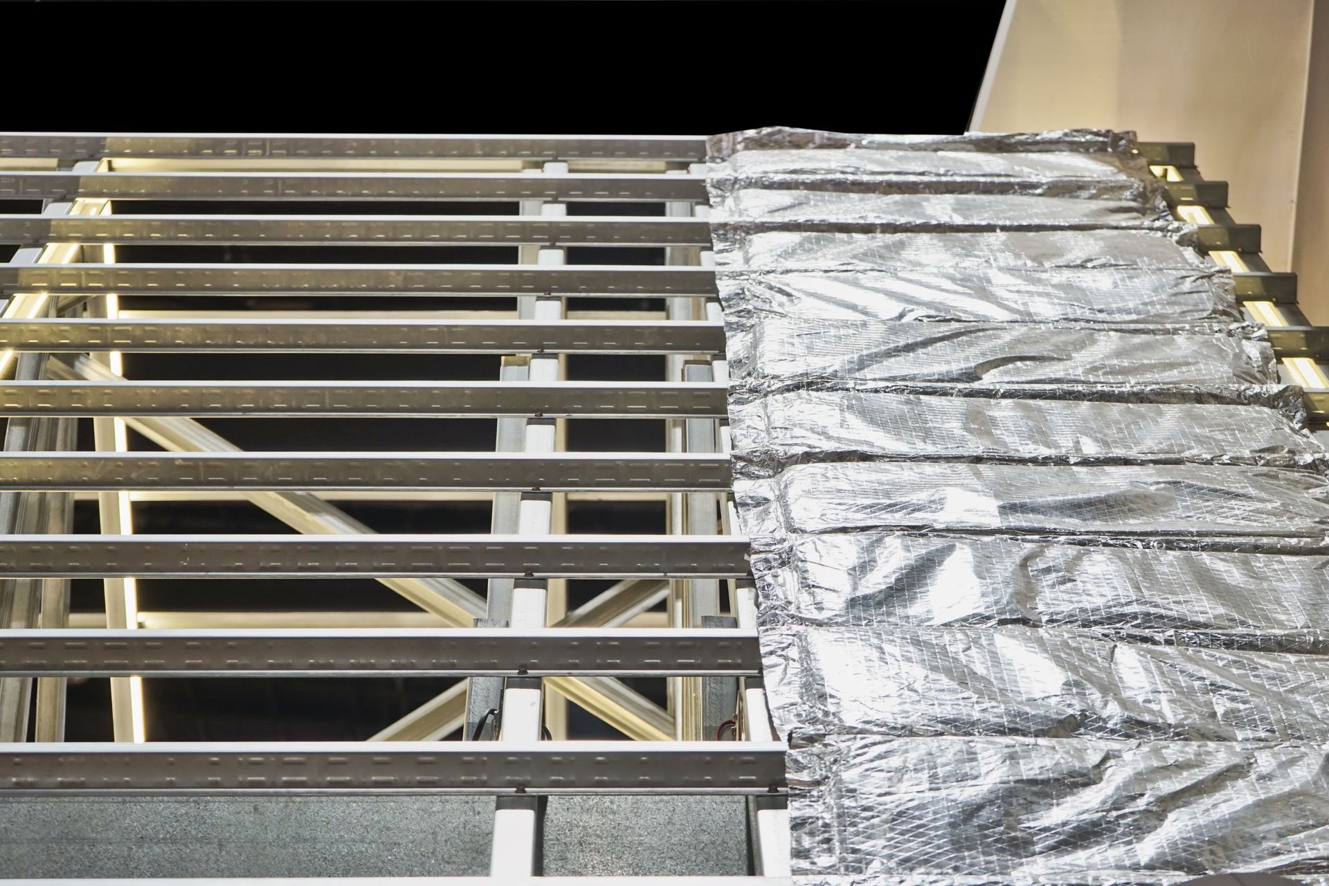 Metal framing beside reflective foil insulation on a ceiling or wall structure