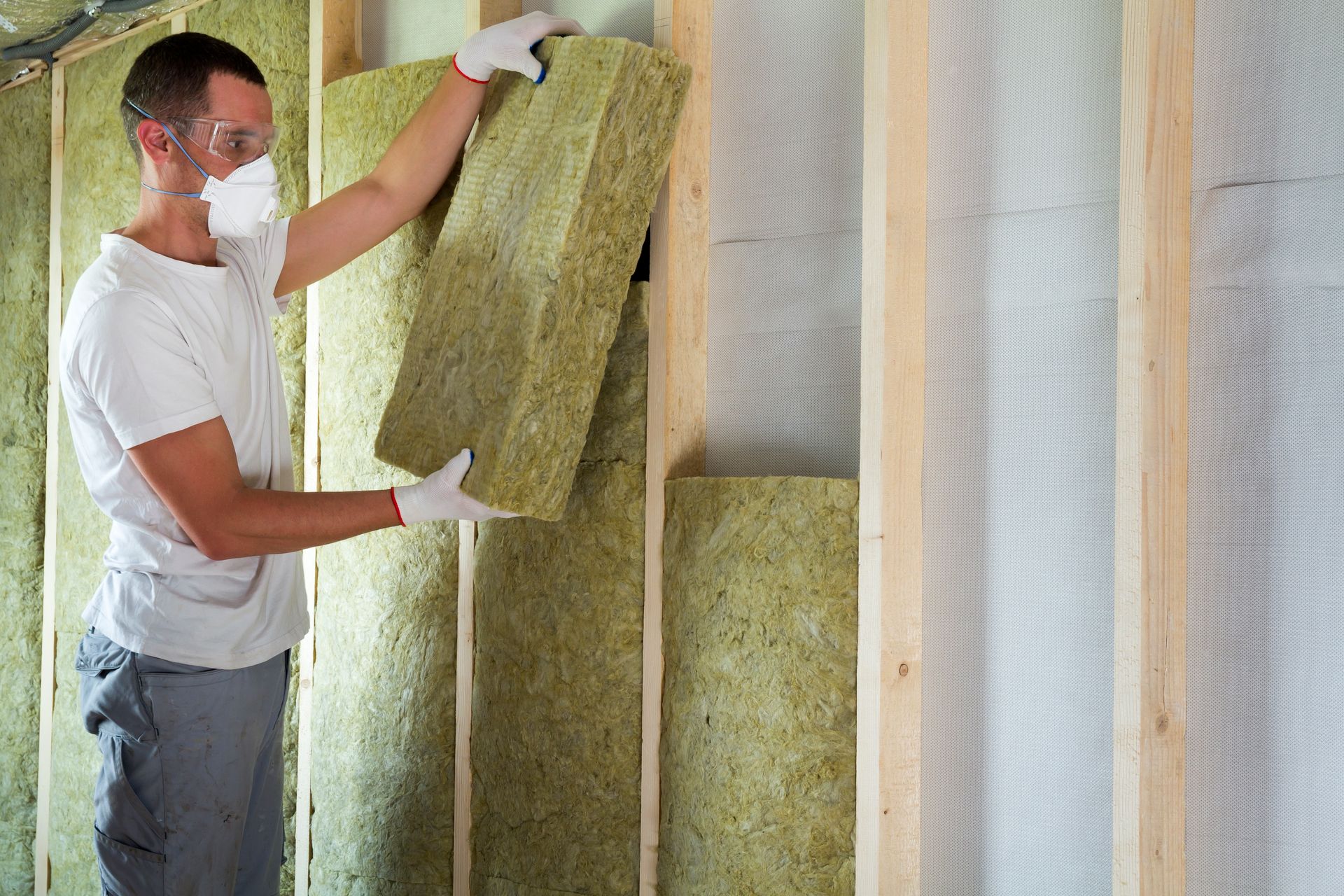 worker insulates the wall