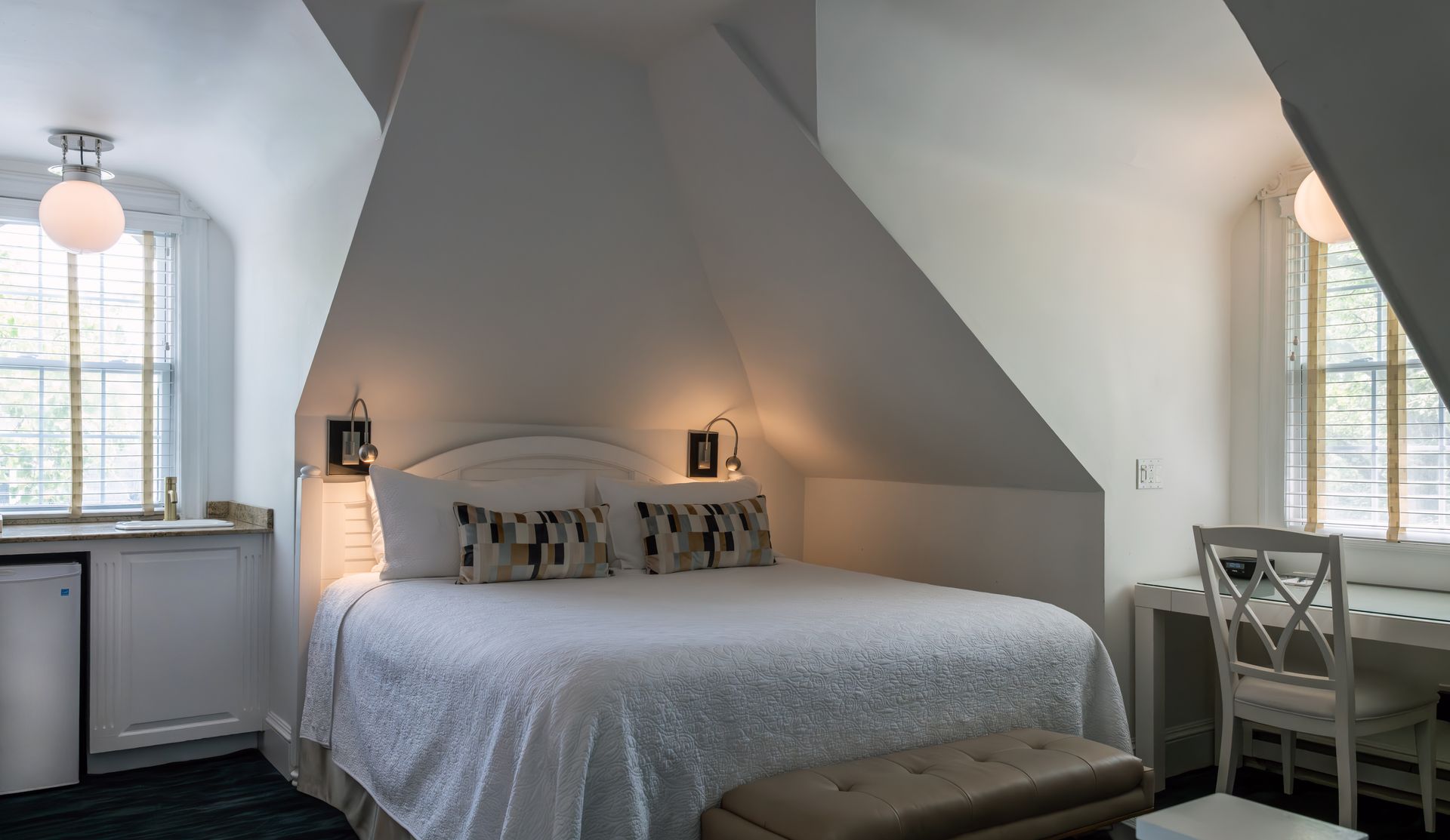 A bedroom with a king size bed and a window