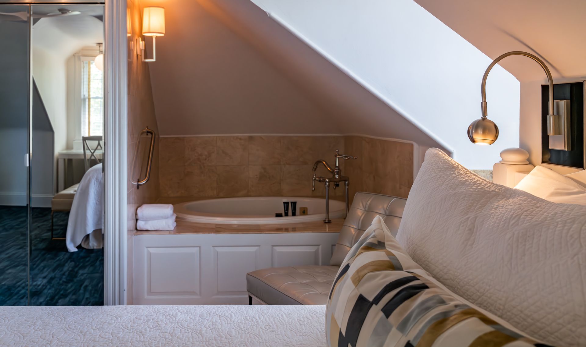 A bedroom with a jacuzzi tub and a couch