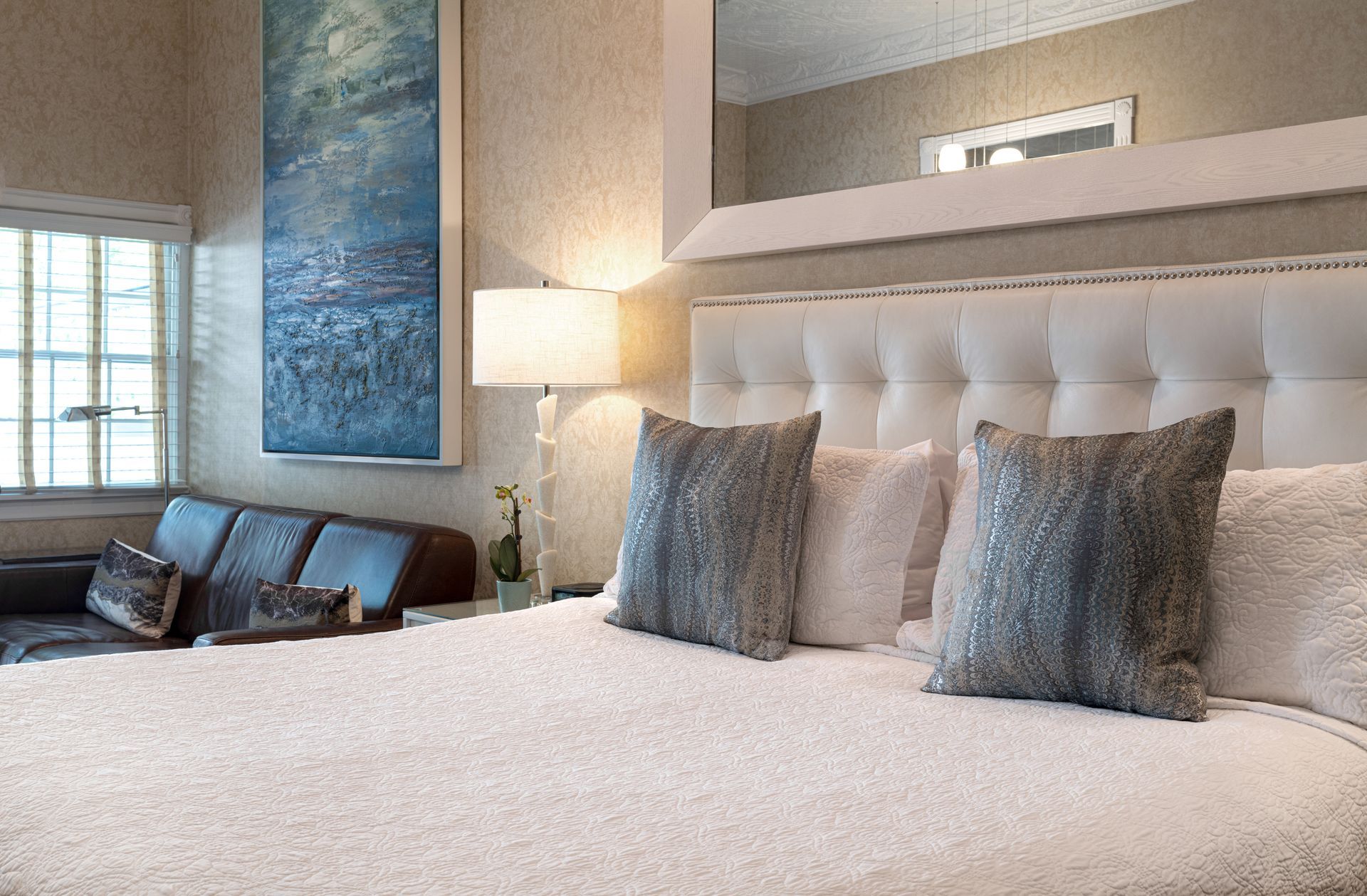 A hotel room with a large bed and a couch
