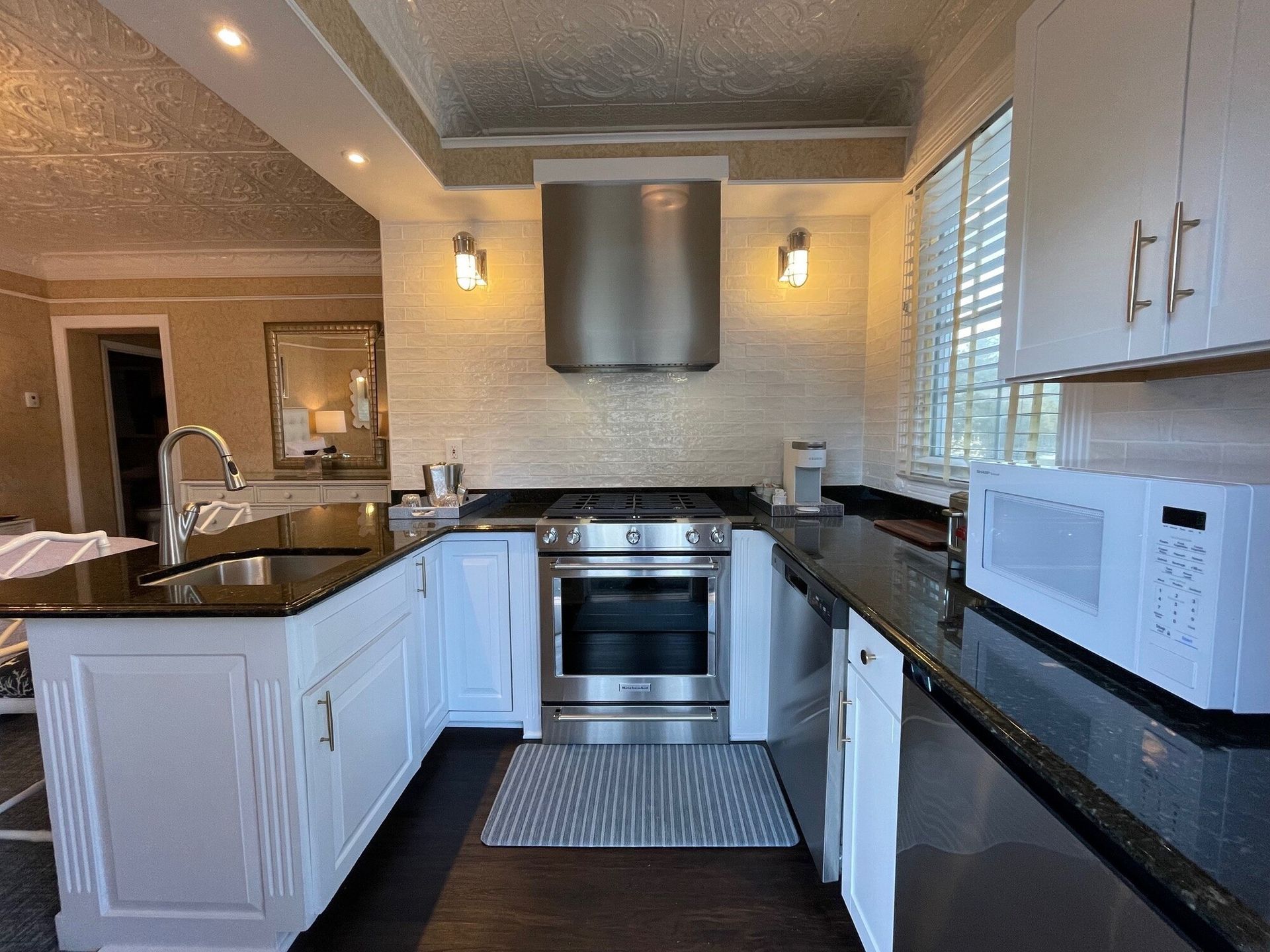 A kitchen with stainless steel appliances and white cabinets