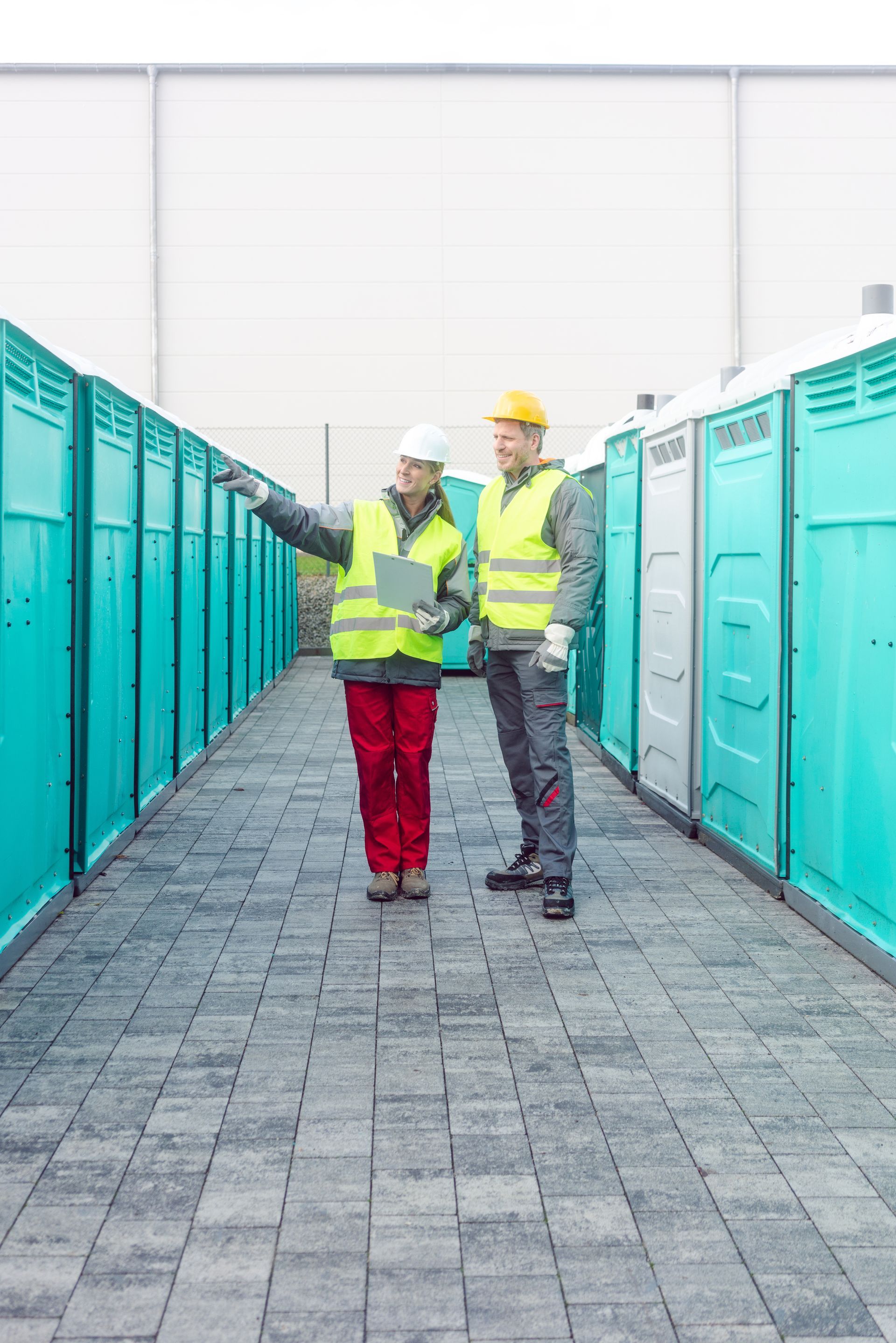 Workers checking the portable toilets for rental.