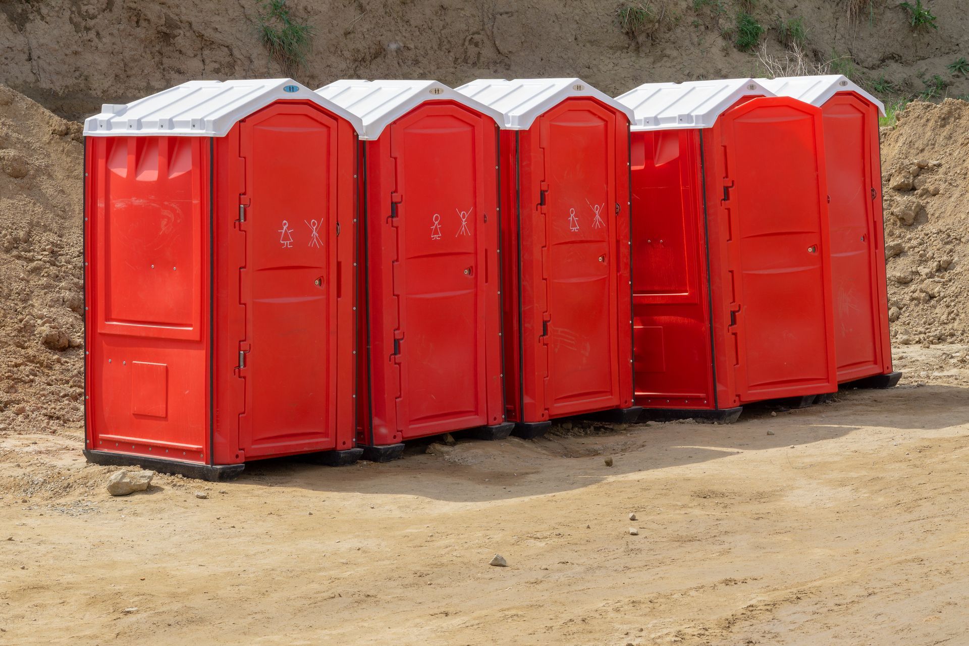 Red portable toilets available for rental, ideal for events and construction sites. service | Worcester, MA |