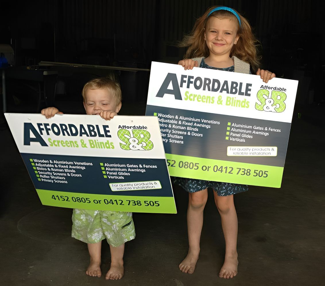A Boy And A Girl Are Holding Up Signs For Affordable Screens And Blinds — Affordable Screens & Blinds in Thabeban, QLD