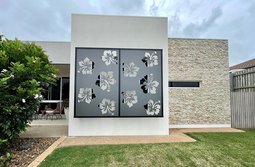 A White House With A Large Screen On The Side Of It — Affordable Screens & Blinds in Thabeban, QLD