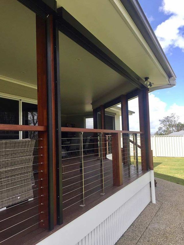 A House With A Large Porch With A Stainless Steel Railing — Affordable Screens & Blinds in Thabeban, QLD
