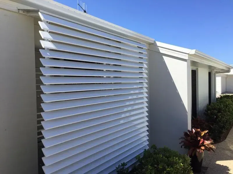 A White House With A White Shutter On The Side Of It — Affordable Screens & Blinds in Thabeban, QLD