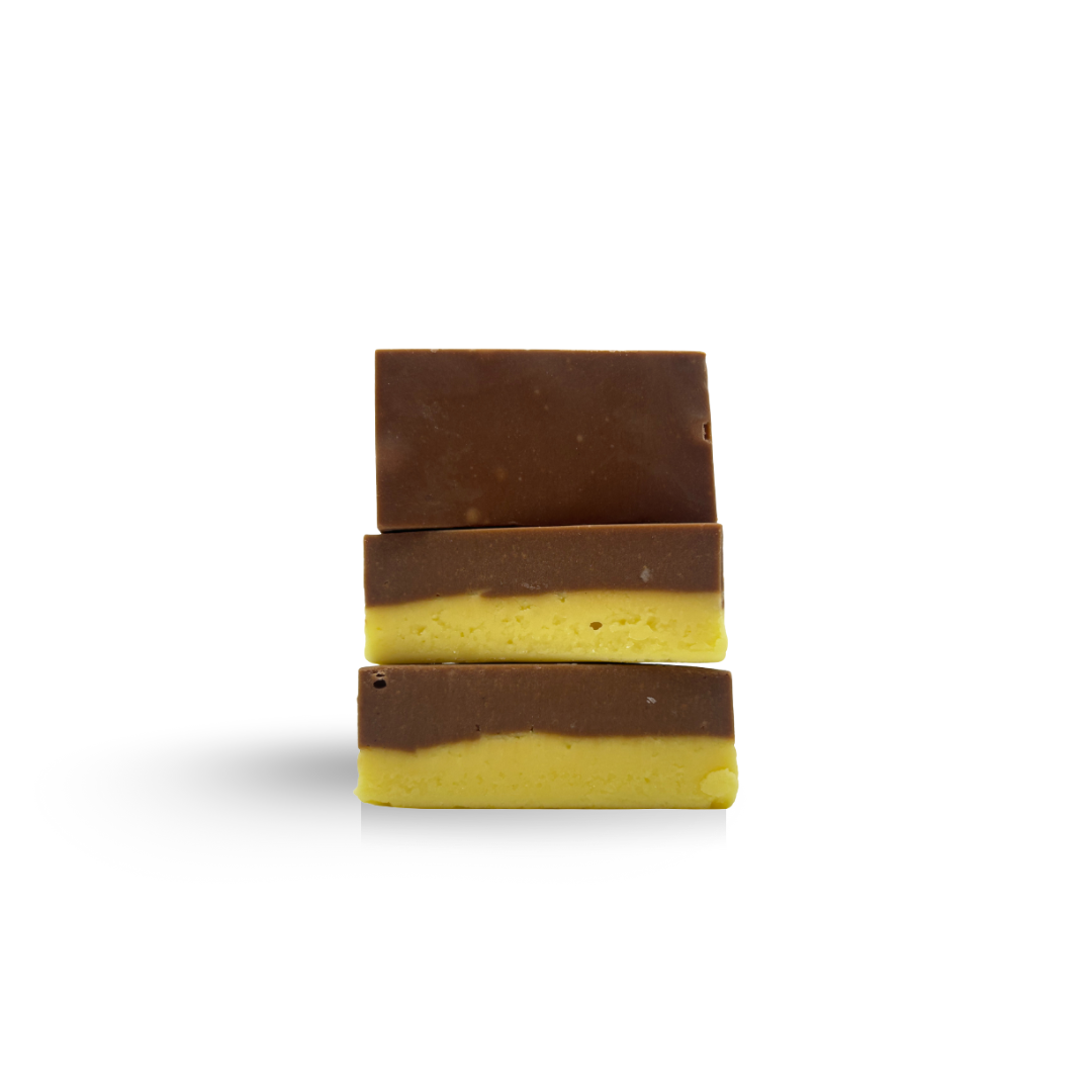 Three stacked pieces of layered fudge: chocolate on top of yellow-tinted fudge.