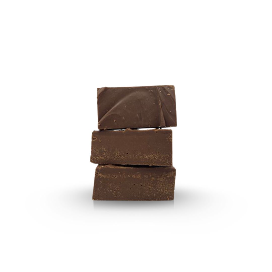 Three stacked, rectangular chocolate fudge pieces against a white background.