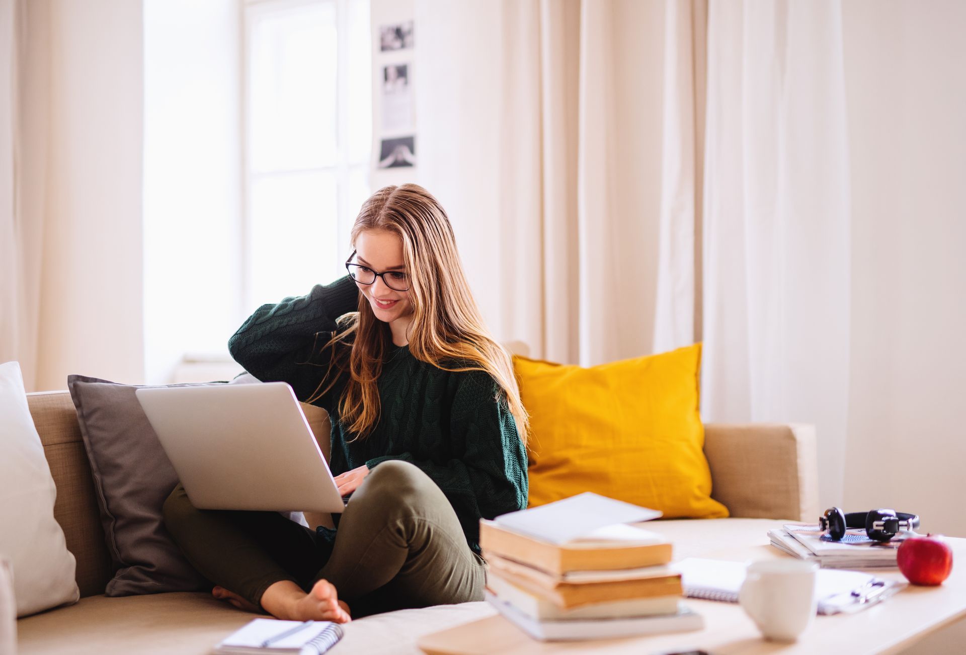 Woman sitting at a table looking at her laptop