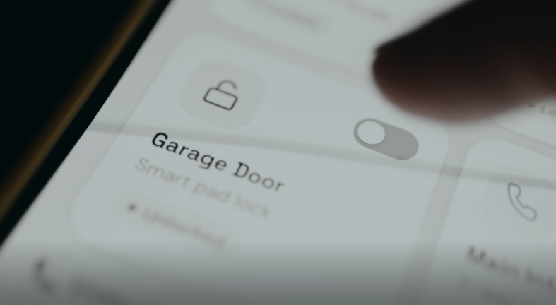 A person locking their garage door using a smart garage door opener on their mobile phone.