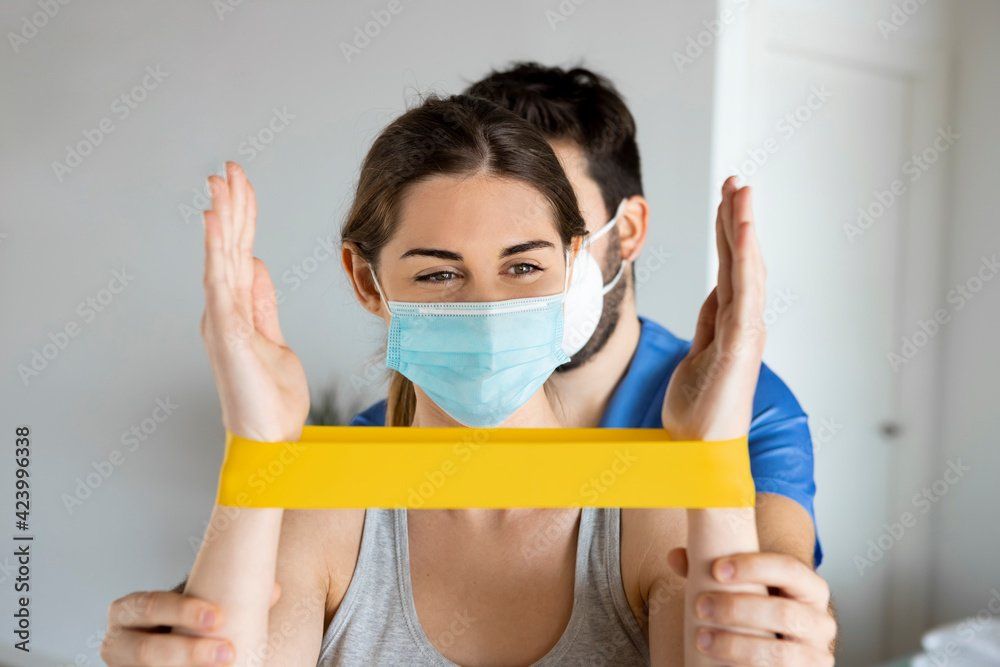 PT working with patient who is using a yellow band.