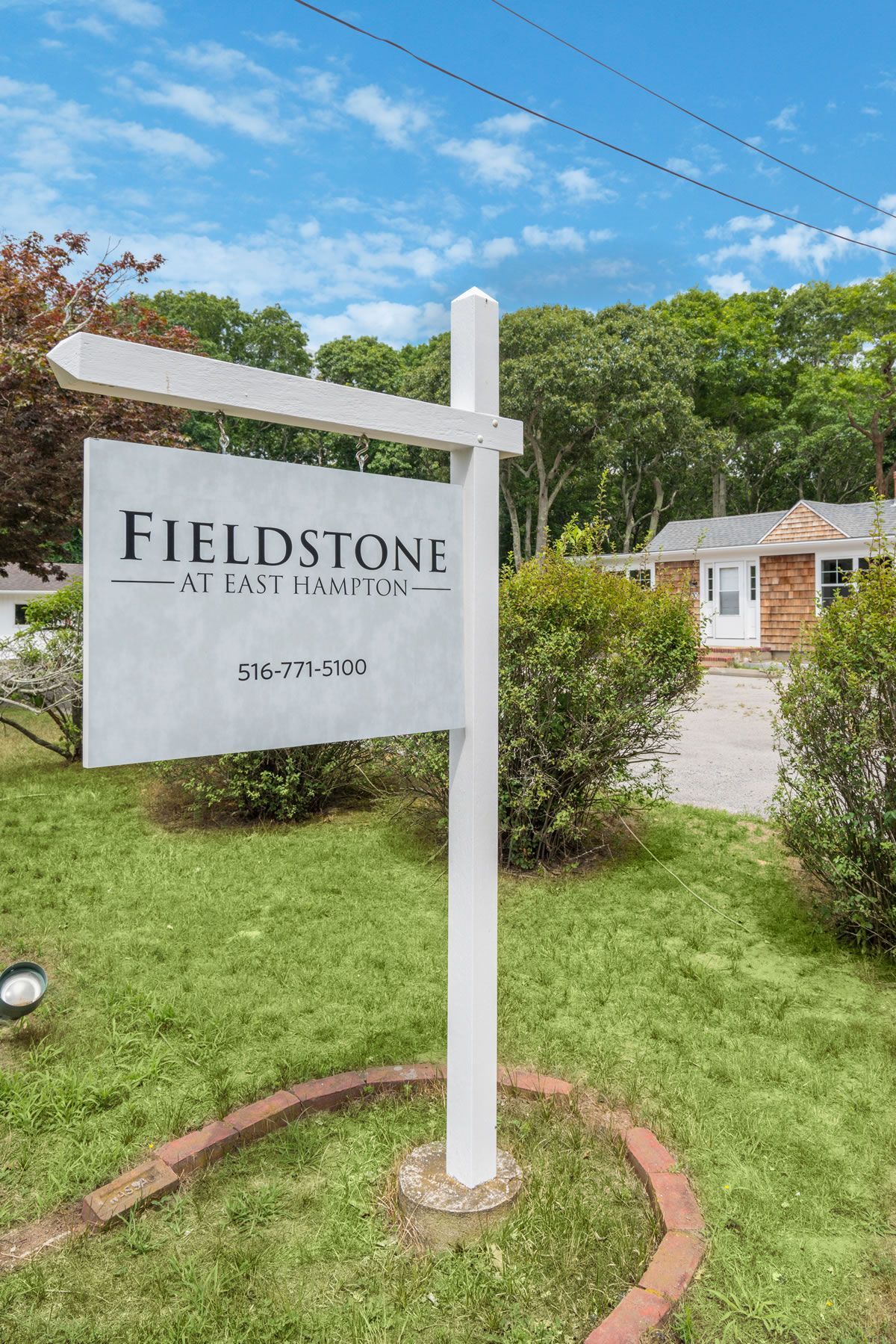 Fieldstone at Sea Pines sign in a landscaped garden under a blue sky