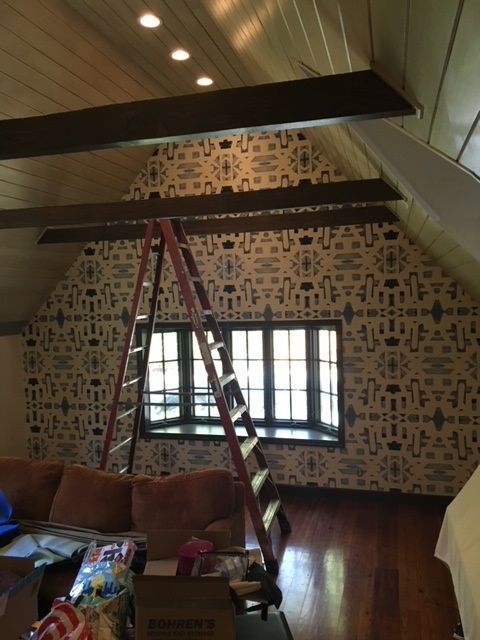 A living room with a ladder in the middle of it