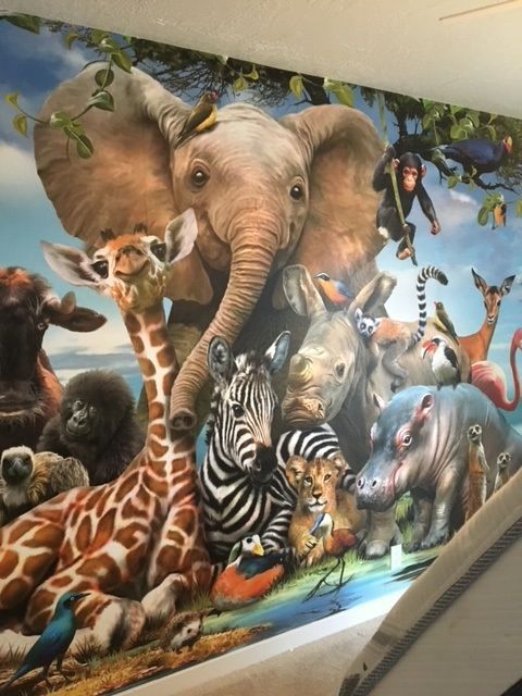 A painting of animals including an elephant giraffe and zebra