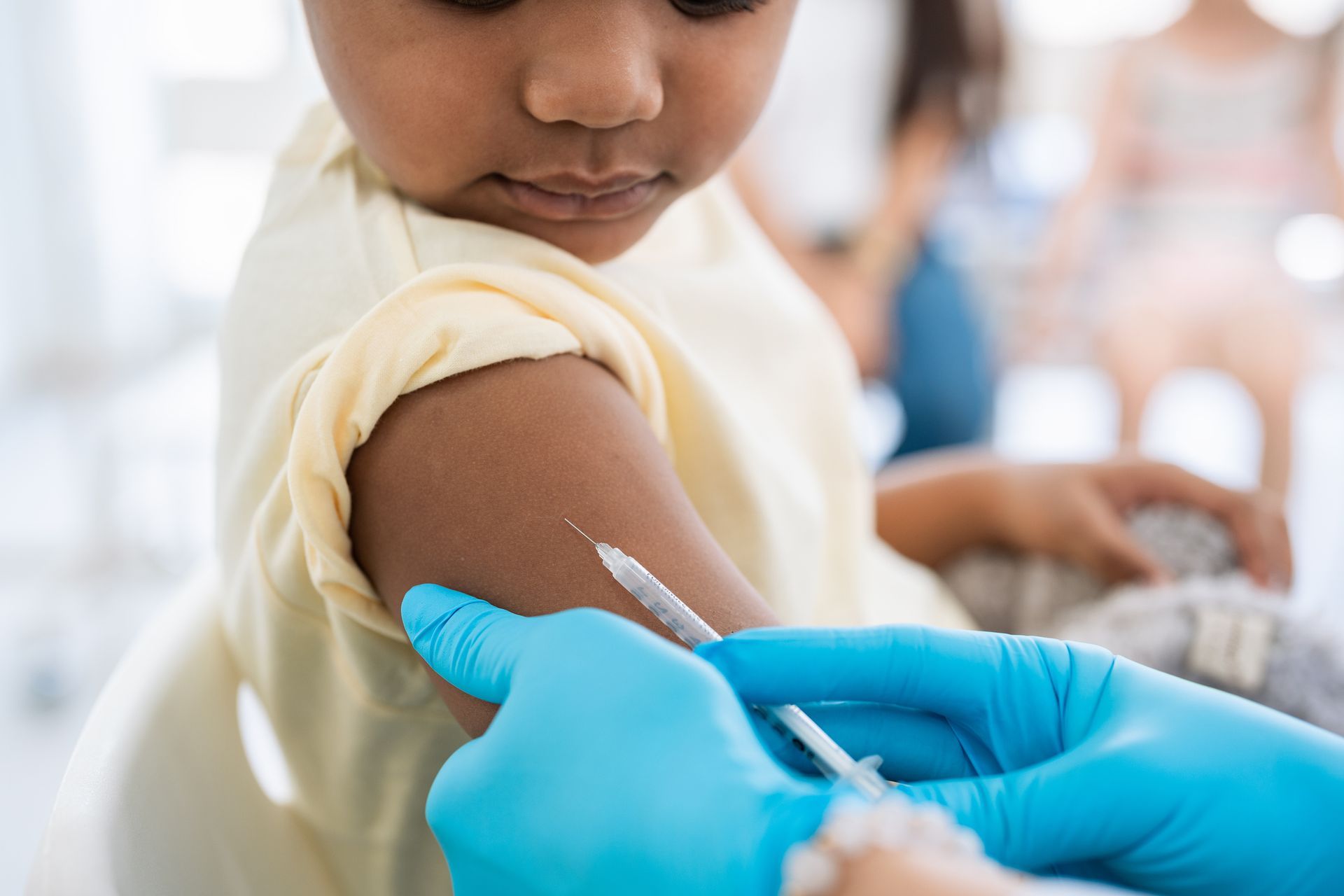 A child receiving an injection from a doctor, promoting sewer immunizations in Indian Land, SC.