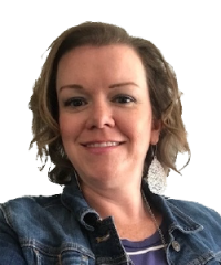 Woman smiles wearing a denim jacket and silver earrings.