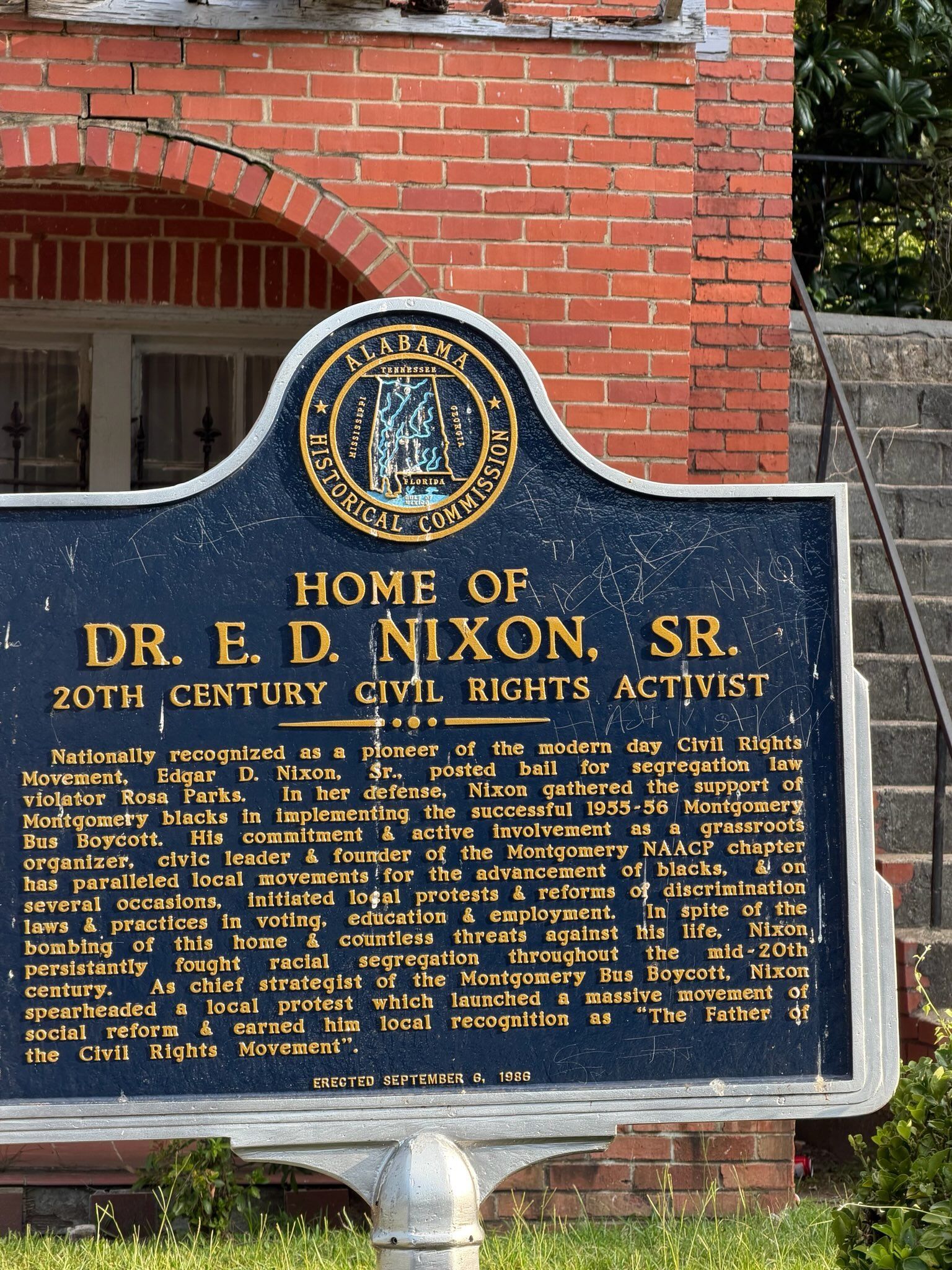 Historic marker for Dr. E. D. Nixon Sr. on a brick building exterior