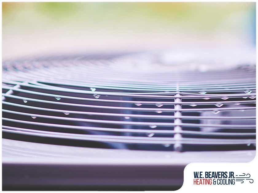 A close up of an air conditioner with the words we beavers jr. heating & cooling on the bottom