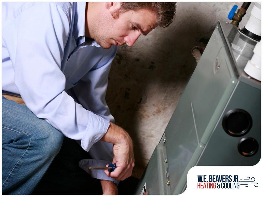A man is working on a heating and cooling system