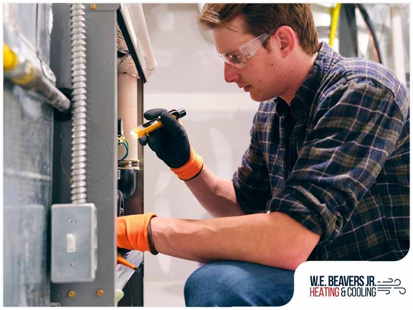 A man is working on a heating and cooling system.