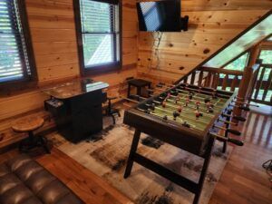 There is a foosball table in the middle of the room.