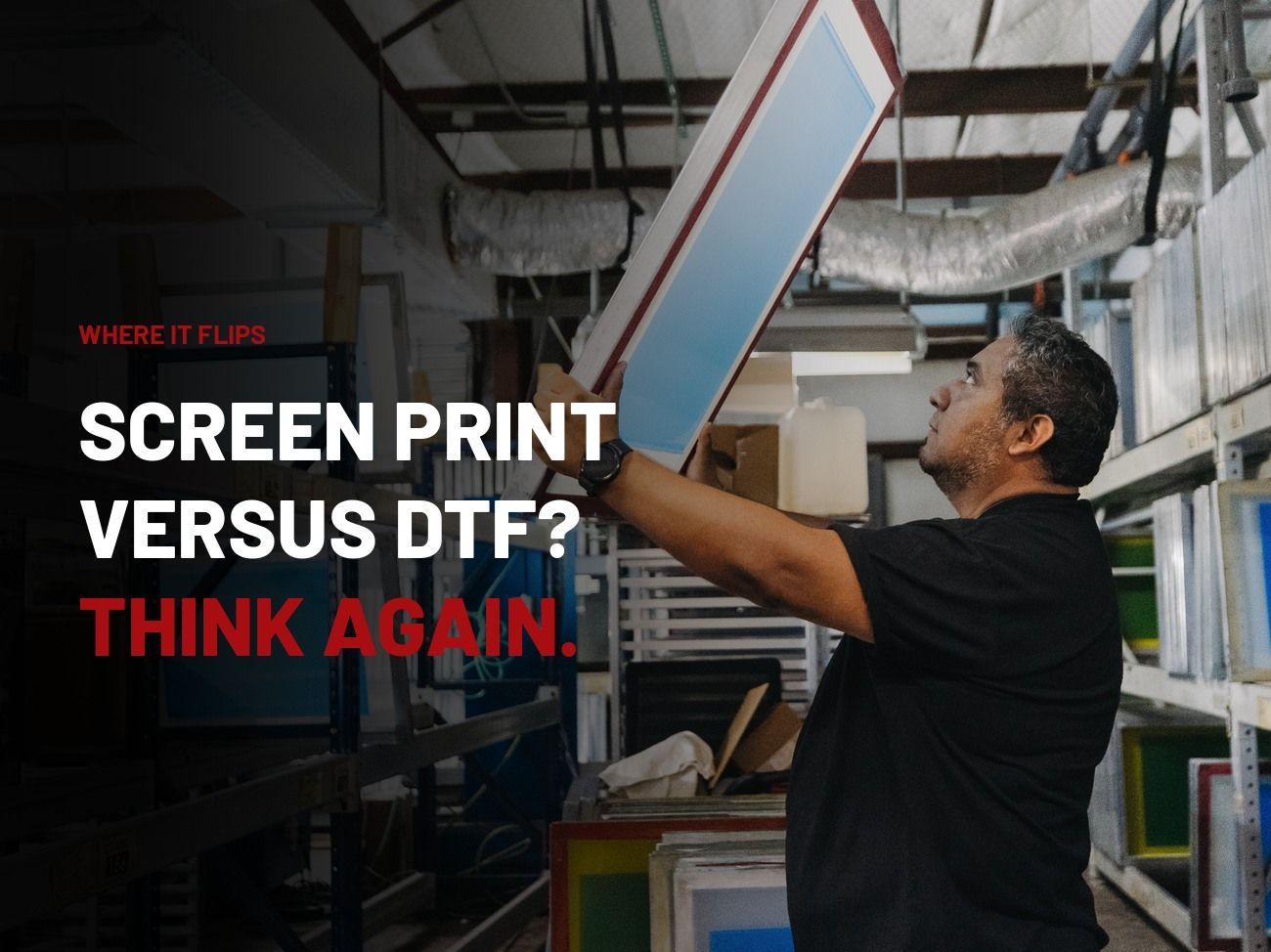 Hightech Grafix team member pulling a coated screen from the racks, screen print versus DTF