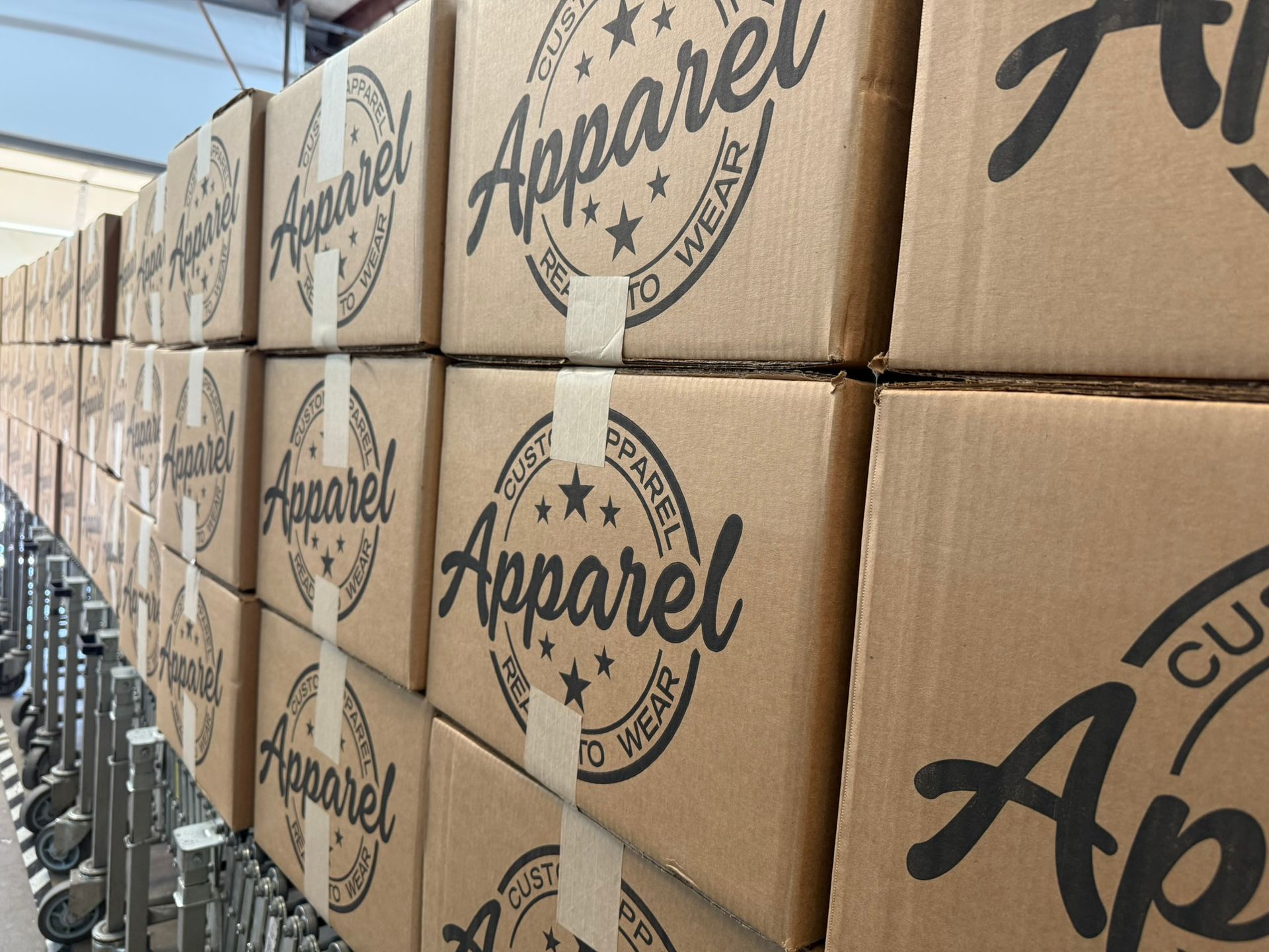 Stacked HTG branded boxes on production conveyor line