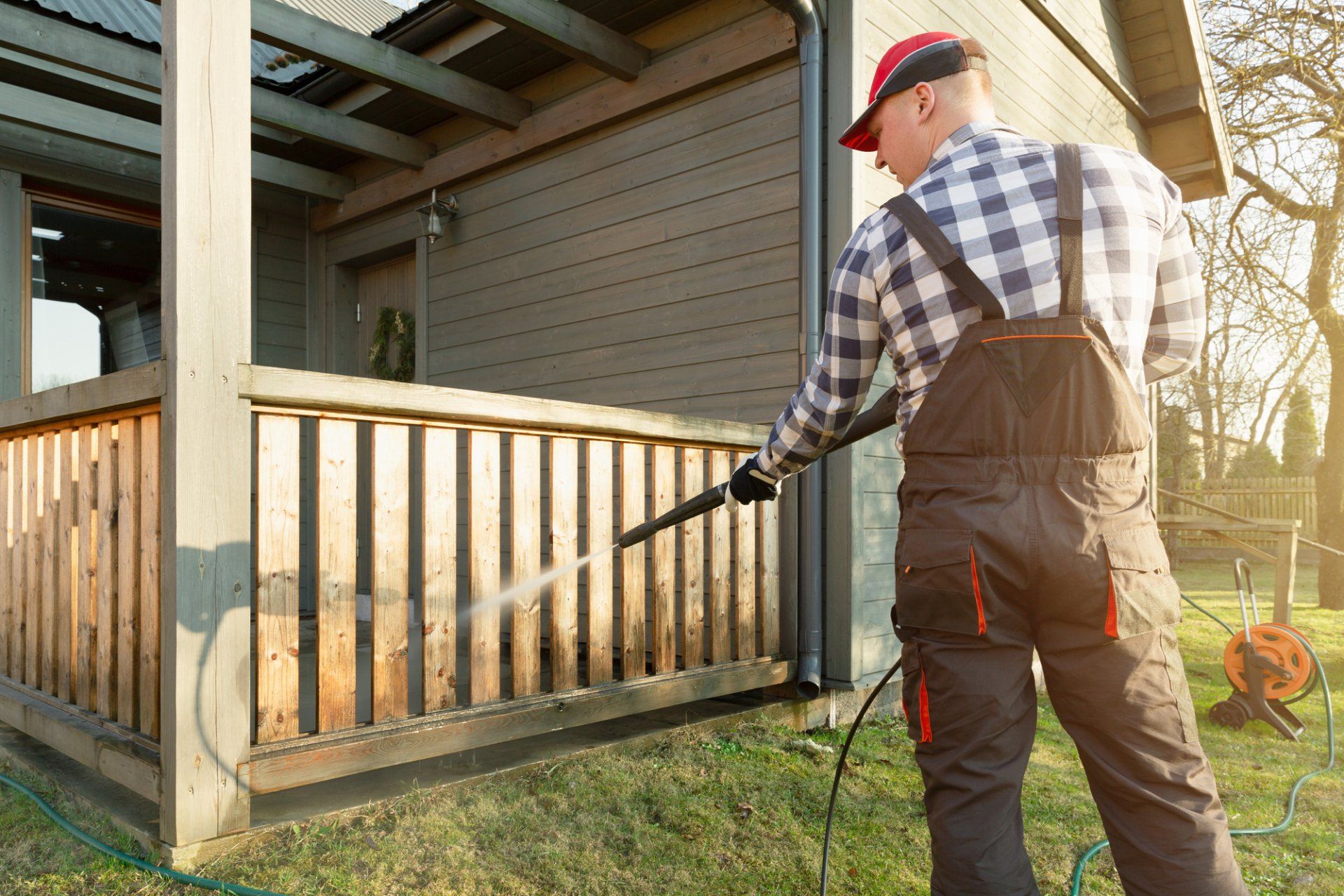 pressure washing company fence cleaning in the backyard of a residential property
