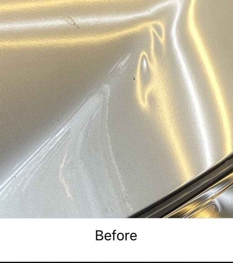 Close-up of a silver car panel with a crease dent and reflection, labeled 